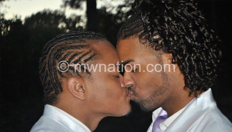 A gay couple shares a kiss at their wedding