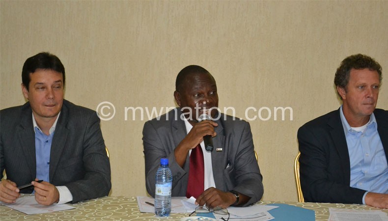 Kanyinji (C) flanked by Rijpma (L) and a UNDP official at the launch