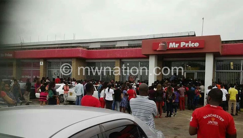 People queue to take advantage of the closing sale at Mr Price shop in Blantyre
