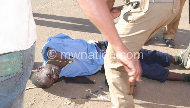 Malawi Police Service officers attending to one of the injured persons at a political event recently.