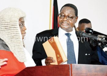 Mutharika being sworn-in yesterday by Chief Justice Msosa (left)