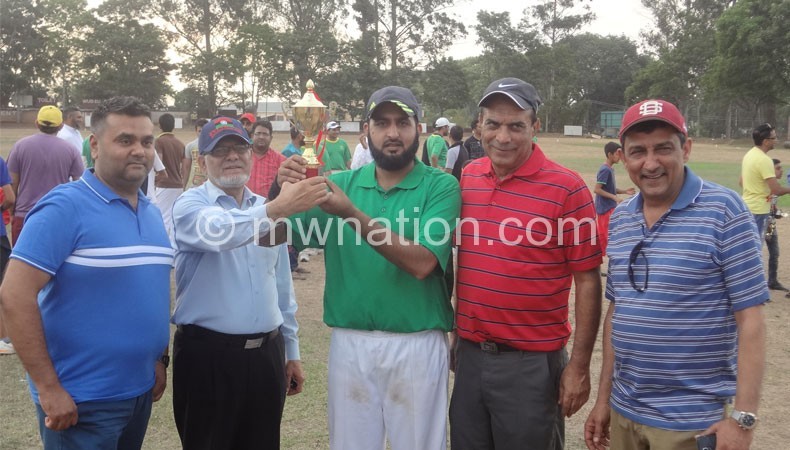 Chaudhry (C) receives a trophy from Nathanie (2ndL) as Jagot (L),
Aboo (2ndR) and Makbul Latif look on