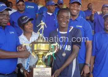 Mataka (2ndL) presents a trophy to Eagles captain as Nyamilandu (2ndR) Saidi (L) and Missi (R) look on