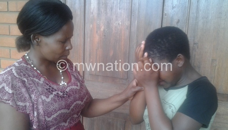 Gertrude (R) breaksdown as she shares her story to Mfulusa