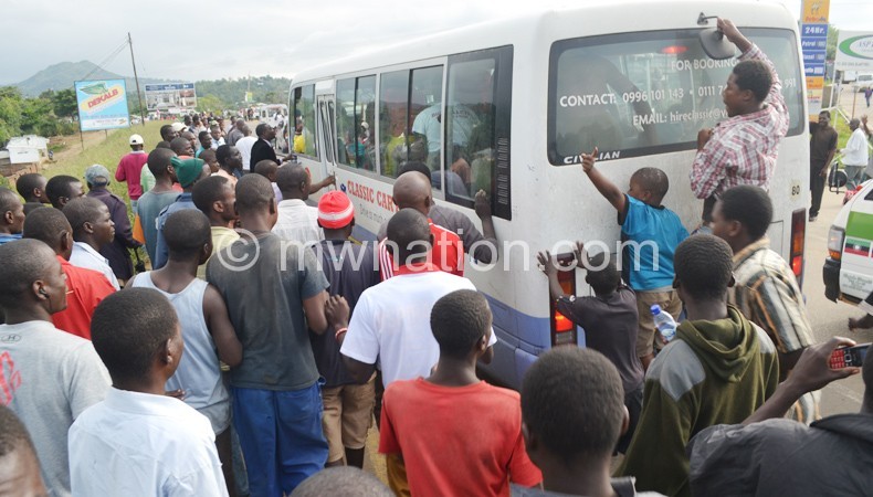 Welcome back home: Blantyre Bullets fans mob the bus carrying the
team as it crawled into the team’s home city
