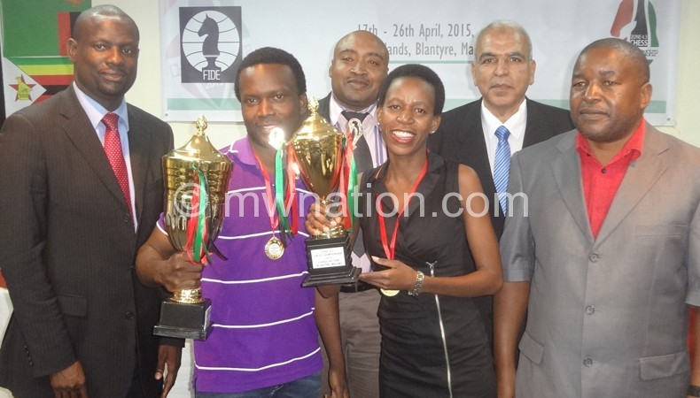 Champions: Phiri and Mudongo show off their trophies as officials look on