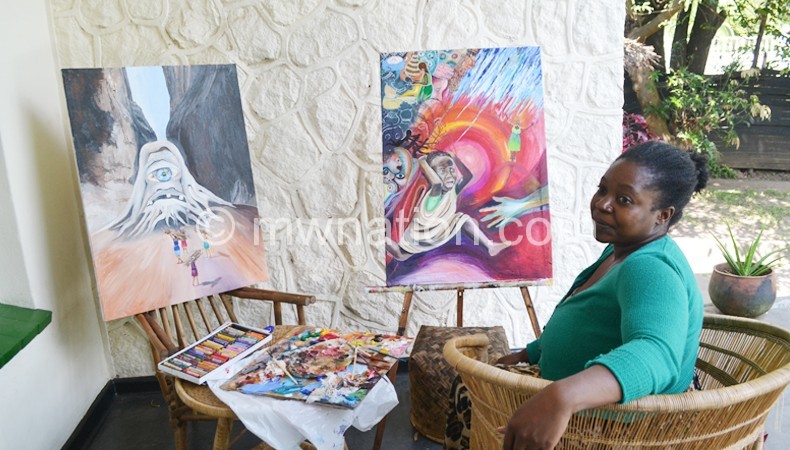 Chikabadwa with her paintings at the symposium