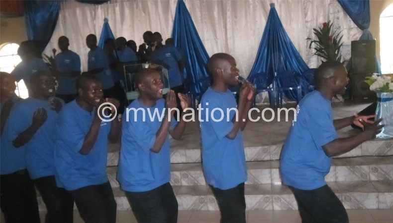 Inmates sing during the church service