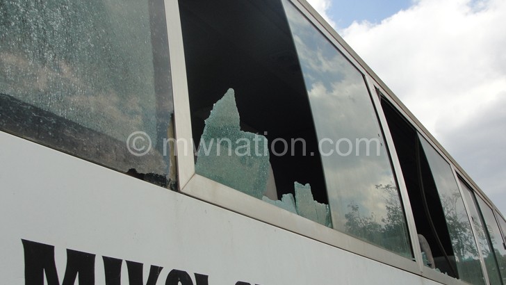 The college bus with broken windows after the fracas
