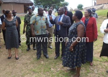 Minister of Information, Tourism and Culture Kondwani Nankhumwa being conducted on a tour of Mpale Cultural Village in Mangochi