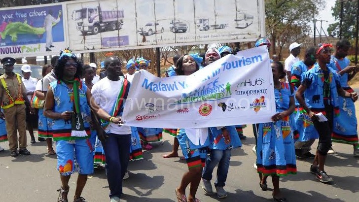 Officials from the public and private sector marching during the street carnival