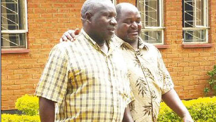 Muzipasi Moyo (L) with co-accused Steven Mwenitete after adjournment yesterday