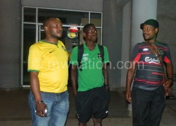 It was a tough one boss!: Mtawali (R) seems to be telling FAM GS Suzgo Nyirenda (L), as midfielder Micium Mhone looks on
