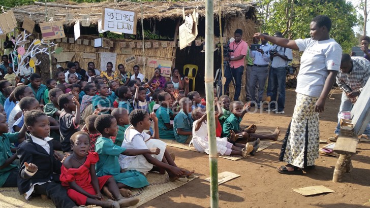 A  Village Camp facilitator teaching children
