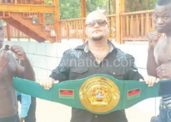 Masamba (R) and Msoliza (L) size up against each other as 
Rousseau holds the belt