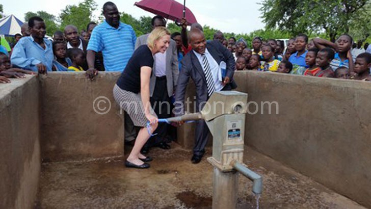 Allen(L) and Mandere pumping water from a borehole