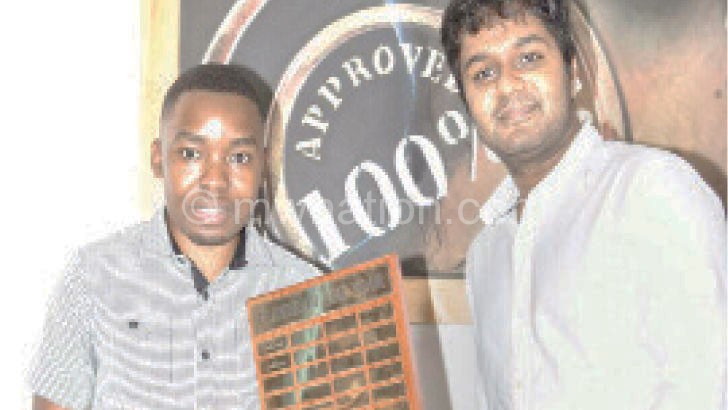 Mwale (L) receiving his trophy from Glenwood chess president Sayen Naidoo