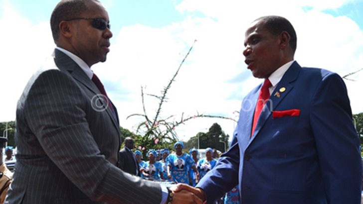 Chilima (L) being welcomed by Minister of Industry and Trade Joseph Mwanamvekha