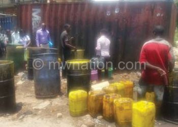 An employee found manually purifying oil behind Limbe Market