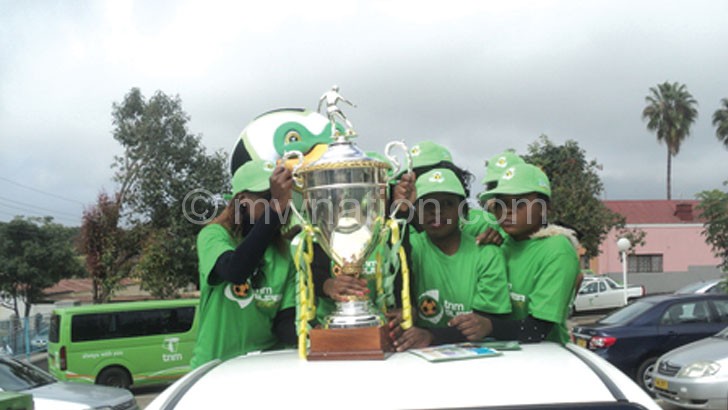 Models show off the TNM Super League Trophy in previous re-launch parade