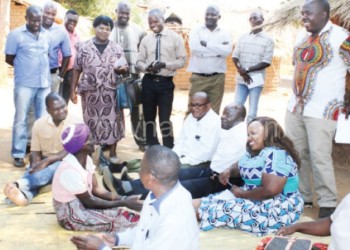 Parliamentary Committee on Social and Community Affairs members interact with a SCTP beneficiary Litiness Levison in Mchinji