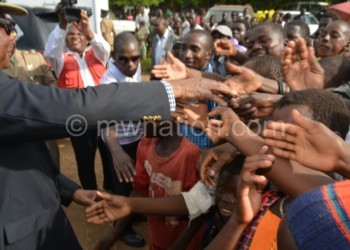 Mutharika greeting some of the people he met in Salima