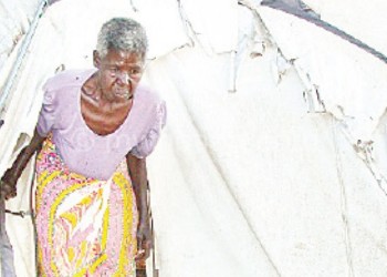 Gogo Sakha walks out of her tent to face another day