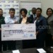 Mataka presents a symbolic cheque to Latif as other FMB and MSC officials look on