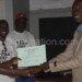 Mzengo (L) presents a certificate of excellence to one of the coaches Limbikani Chiumia