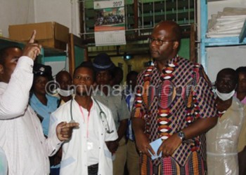 Muluzi (R) gets a briefing from hospital
 officials