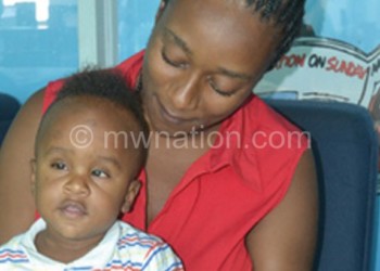 Struggling with sight: Chimwemwe with his mother