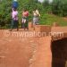 Women cross a bridge constructed with CDF funds
