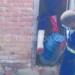 Sanitation workers take out faecal sludge from a pit latrine