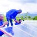 Kankulungo (C) and his team assemble solar panels for the power boosting system
