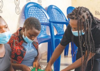 Kwanjana teaches the girls to sew pads