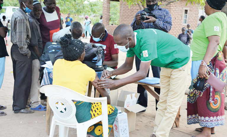 A community health worker administers the Covid-19 vaccine