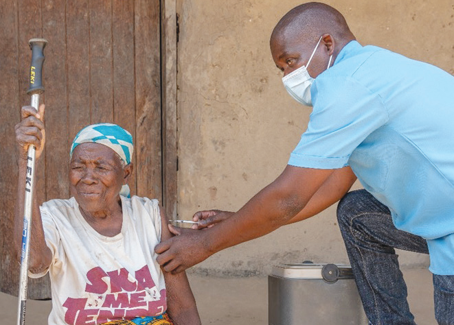 A woman gets her Covid-19 jab during the Ministry of Health door-to-door campaign