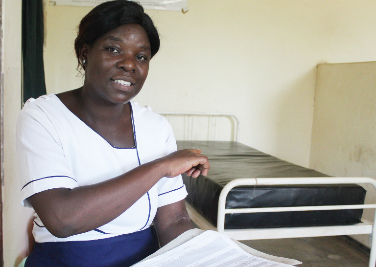 Nurse helps women give birth using phone light