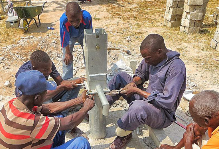 Artisans fix a water point in Chiradzulu, where 38 percent of pumps do not function